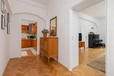 a living room with a table and a mirror at Spacious Retro Apartment in the Center of Cracow by Noclegi Renters in Kraków
