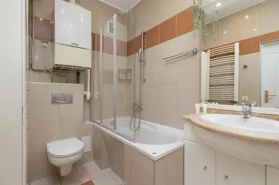 a bathroom with a sink and a toilet and a shower at Spacious Retro Apartment in the Center of Cracow by Noclegi Renters in Kraków
