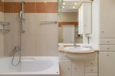 a bathroom with a shower and a sink and a tub at Spacious Retro Apartment in the Center of Cracow by Noclegi Renters in Kraków
