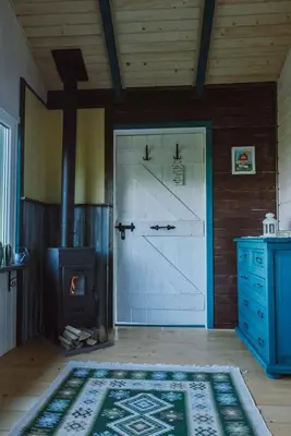 a room with a barn door and a stove at RESETówka nr 1 - chatka na odludziu z mega widokami & leśne SPA in Jaszczurowa