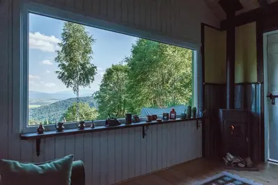a large window in a room with a view of trees at RESETówka nr 1 - chatka na odludziu z mega widokami & leśne SPA in Jaszczurowa