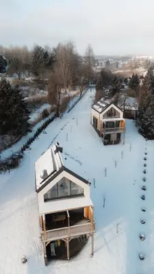 an aerial view of a house in the snow at Cienista Dolina in Brzoskwinia