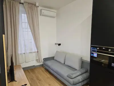 a living room with a couch and a television at Apartamenty Skawińska 10 in Kraków