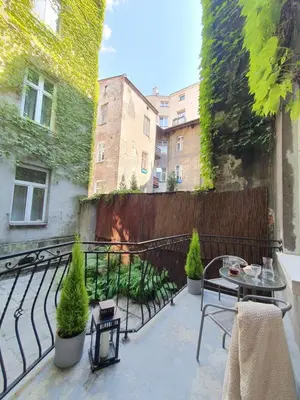 a balcony with a table and chairs and a fence at Z-1 Kraków Old Town O&P ApartFamily in Kraków