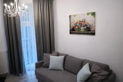 a living room with a couch and a painting on the wall at Z-1 Kraków Old Town O&P ApartFamily in Kraków