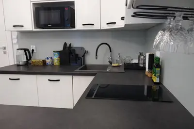 a kitchen with a sink and a microwave at Z-1 Kraków Old Town O&P ApartFamily in Kraków