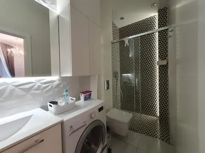 a bathroom with a washing machine and a shower at Z-1 Kraków Old Town O&P ApartFamily in Kraków