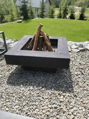 a fire pit sitting on a pile of rocks at Mucharskie Stodoły Stodoła II - Garden Spa in Jaszczurowa