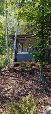 a house in the middle of a forest with trees at Mucharskie Stodoły Stodoła II - Garden Spa in Jaszczurowa