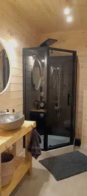a bathroom with a glass shower with a sink at Mucharskie Stodoły Stodoła II - Garden Spa in Jaszczurowa