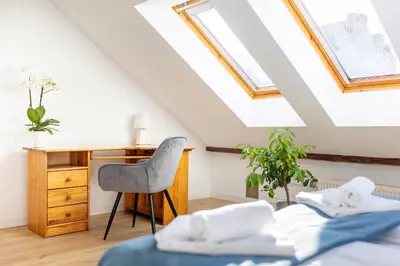 a bedroom with a bed with a towel on it at Apartment with Entresol Old Town Krakow in Kraków