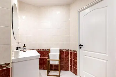 a bathroom with a white sink and a mirror at Apartment with Entresol Old Town Krakow in Kraków