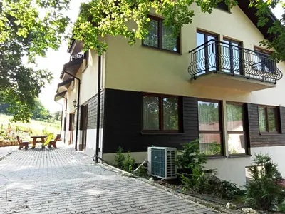 a building with a balcony on the side of it at Agroturystyka Premium Cracovia Arabians - Ojcowski Park Narodowy in Maszyce