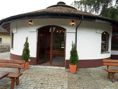 a small white building with two benches in front of it at Agroturystyka Premium Cracovia Arabians - Ojcowski Park Narodowy in Maszyce