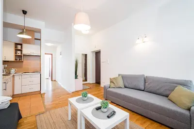 a living room with a couch and a table at Apartment Krakowska City Center WAWELOFTS in Kraków