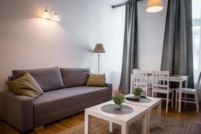 a living room with a couch and a table at Apartment Krakowska City Center WAWELOFTS in Kraków