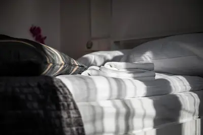 a couch with a pile of towels on it at Apartment Krakowska City Center WAWELOFTS in Kraków