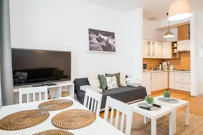 a living room with two tables and a couch at Apartment Krakowska City Center WAWELOFTS in Kraków