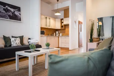 a living room with a couch and a table at Apartment Krakowska City Center WAWELOFTS in Kraków