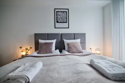 a bedroom with a large bed with two towels on it at Apartament Bliss 16 Zator by Housine in Zator