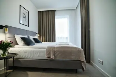 a bedroom with a large bed and a window at Apartament Bliss 16 Zator by Housine in Zator