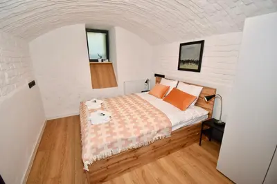 a bedroom with a bed with orange pillows at Kraków Family Nest in Kraków