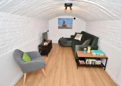 a living room with a couch and a table at Kraków Family Nest in Kraków