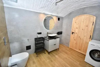 a bathroom with a sink and a toilet and a mirror at Kraków Family Nest in Kraków