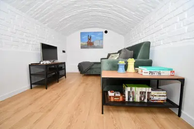 a living room with a couch and a table at Kraków Family Nest in Kraków