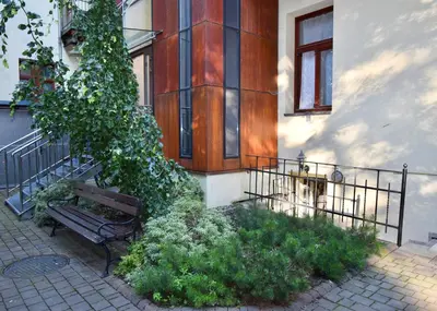 a bench sitting in front of a building at Kraków Family Nest in Kraków