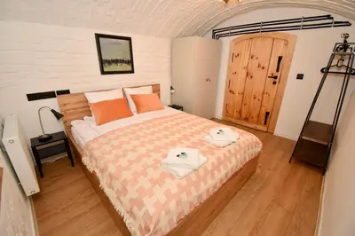 a bedroom with a bed with two towels on it at Kraków Family Nest in Kraków