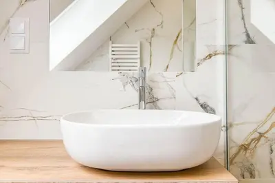 a bathroom with a white bowl sink on a table at Apartament Ptasi Śpiew 2 in Rabka