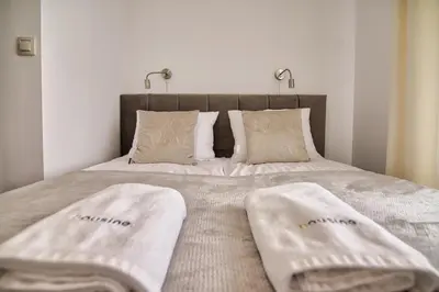 a bedroom with a bed with two towels on it at Apartament Lider 41 by Housine in Zator