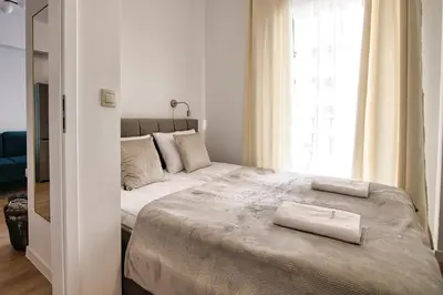 a bedroom with a large bed with a window at Apartament Lider 41 by Housine in Zator