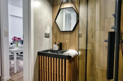a bathroom with a sink and a mirror at Apartament Lider 41 by Housine in Zator