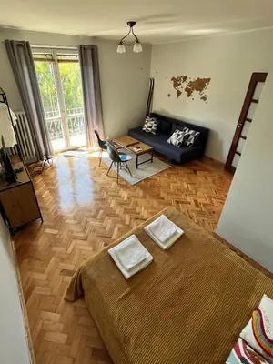 a living room with a bed and a couch at Apartament Globtroter in Kraków