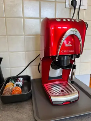 a red coffee maker sitting on top of a kitchen counter at Apartament Globtroter in Kraków