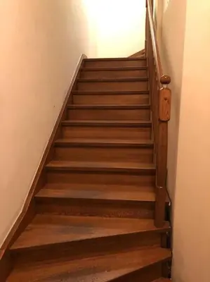 a stairway with wooden steps in a building at Lux apartmenty - Old City Kraków in Kraków