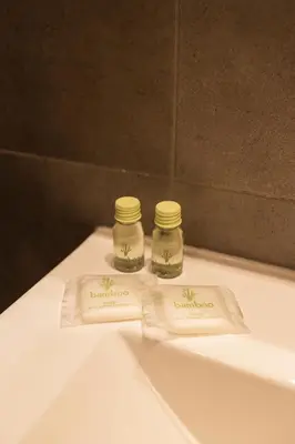 two jars sitting on top of a bathroom sink at Lux apartmenty - Old City Kraków in Kraków