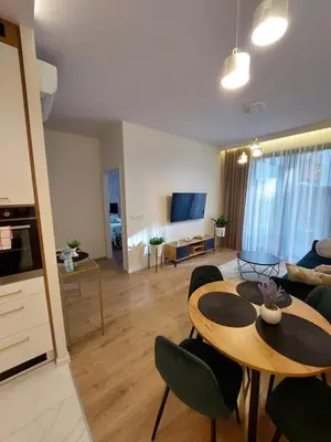 a living room with a table and chairs and a couch at Apartament Aktorów Bronowice in Kraków
