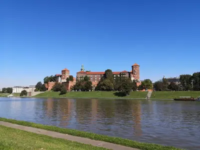 a large building next to a large body of water at Apartament Piccolo in Kraków