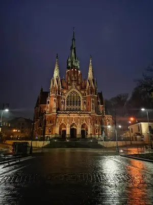 a large building is lit up at night at Apartament Piccolo in Kraków