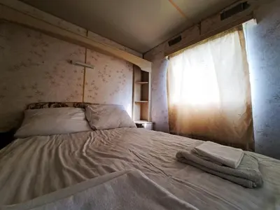 a bed with two towels on it in a bedroom at Pensjonat Łysa Góra in Zator