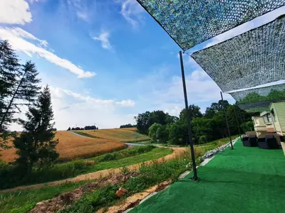 a view of a field from under a pergola at Pensjonat Łysa Góra in Zator