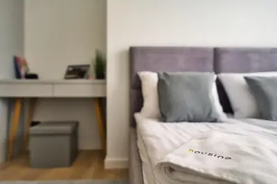 a bedroom with a bed with a table and a bed sidx sidx sidx at Golden 42 in Zator