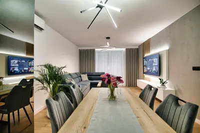 a dining room and living room with a table and chairs at Golden 42 in Zator