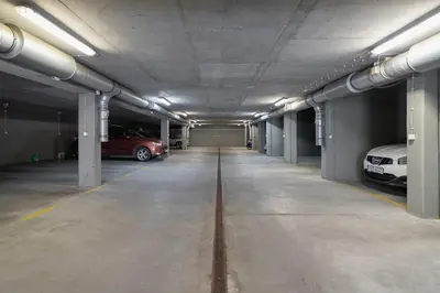 a parking garage with two cars parked in it at Cozy Apartment Bartla 19 by Noclegi Renters in Kraków