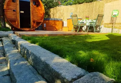 a garden with a table and chairs in a yard at Alpakowy raj in Nowy Targ