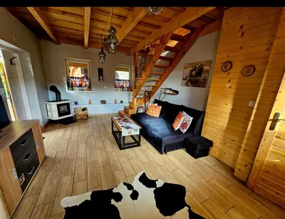 a living room with a cow rug on the floor at Alpakowy raj in Nowy Targ