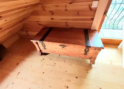 a wooden room with a bench in the attic at Alpakowy raj in Nowy Targ